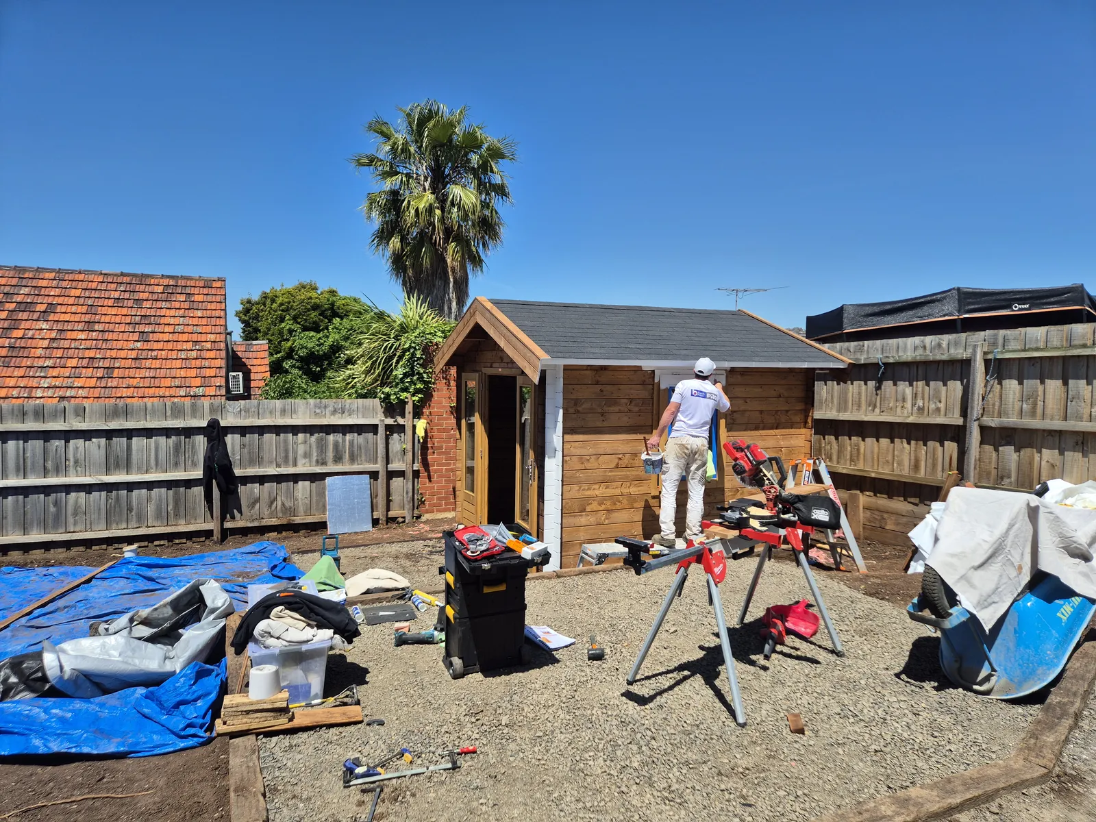 Spraying the white undercoat onto the cabin exterior